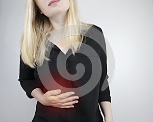 A woman grabs his right side under the ribs. Pain in the liver. Pain syndrome in liver disease. Hepatologist examination