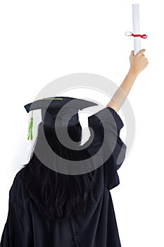 Woman in graduation gown celebrating success