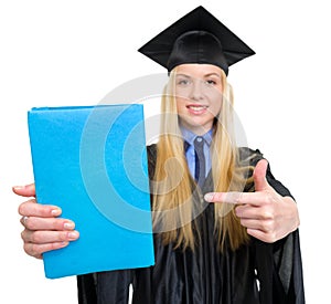 Woman in graduation gown pointing on book