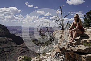 Woman in Grand Canyon. Carefree freedom concept. Life girl winner at cliff.