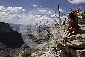 Woman in Grand Canyon National Park. Life winner. Carefree freedom concept. Girl at cliff. Successful female.