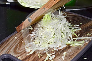 A woman grates cabbage for borscht