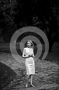 Woman on gravel path in park. Black and white photo.