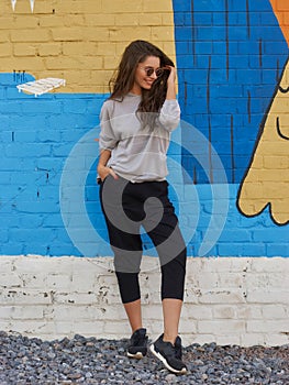 Woman in gray hoodie and black trousers