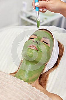 woman with green alginate mask on face
