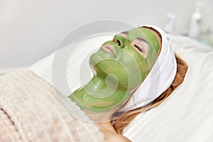 woman with green alginate mask on face