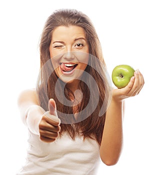 Woman with green apple and showing thumb up