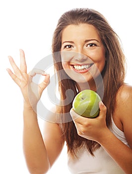 Woman with green apple and showing thumb up