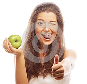 Woman with green apple and showing thumb up