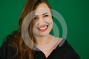 woman on a green background chromakey in a black striped mens shirt different emotions facial expression close-up