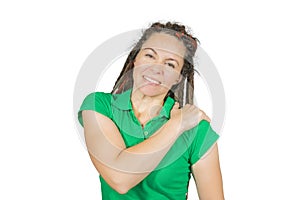 Woman in green casual t-shirt and modern dreadlock haircut with shoulder pain. Isolated medical shot over white background