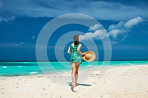 Woman in green dress at beach