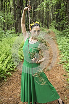 Woman in green dress, dancing in the Connecticut woods