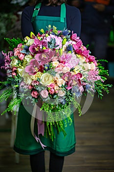 Woman in Green Dress Holding Bouquet of Flowers