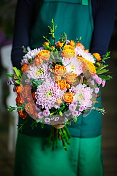 Woman in Green Dress Holding Bouquet of Flowers