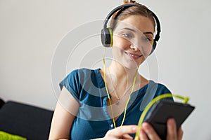 Woman With Green Earphones Listens Podcast Music On Telephone