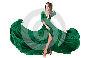 Woman Green Fashion Dress. Model in Long Evening Slit Gown waving on Wind. Fashionable Beauty Girl dancing on Isolated White