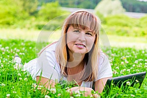 Woman in green grass with flowers