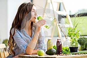 Woman with green healthy food and drinks at home