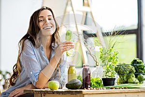 Woman with green healthy food and drinks at home