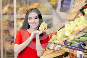 Woman with Green Pepper Shopping for Groceries in a Supermarket