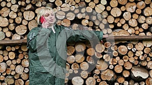 Woman in green raincoat with red mobile phone