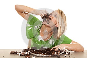 Woman green shirt with cake elbow up stuff in mouth