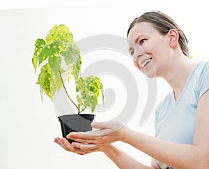 Woman with green sprout of tree