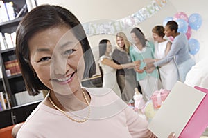 Woman With Greeting Card At A Baby Shower