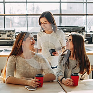 Woman greeting her friends waiting for her at cafe