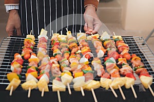 A woman grilling barbecue in dinner party. Food  people and family time concept