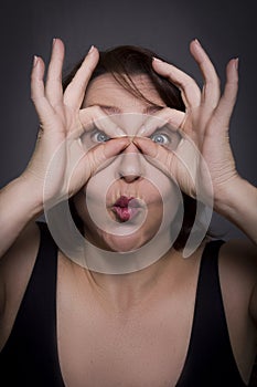 Woman grimaces in front of camera