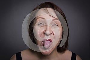 Woman grimaces in front of camera