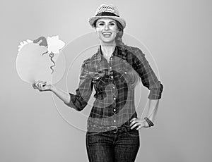 Woman grower on yellow background showing copy space pumpkin