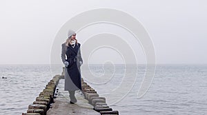 Woman on Groynes in the Baltic Sea during winter