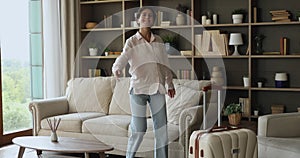 Woman guest or new tenant carrying suitcase enters living room