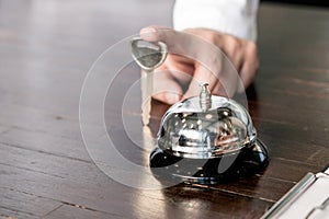 Woman guest at the reception of hotel checking in