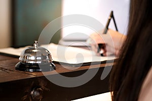 Woman guest at the reception of  hotel checking in