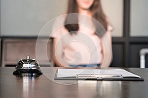 woman guest at the reception of  hotel checking in