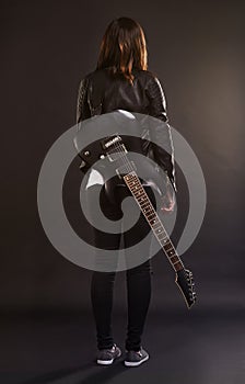 Woman, guitar and fashion for musical instrument, sound and trendy for retro and style on dark background. Young person