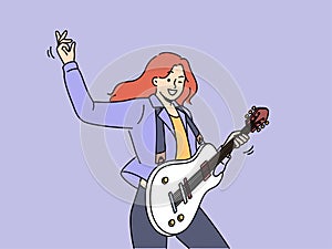 Woman with guitar plays rock music at concert and enjoys creative hobby and winks looking at screen