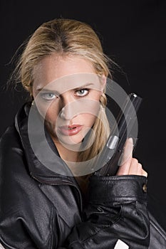 woman with gun in leather jacket