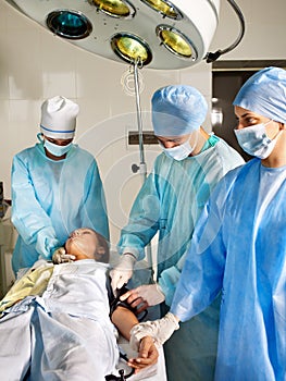 Woman on gurney in operating room.