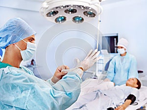 Woman on gurney in operating room.