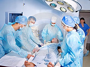 Woman on gurney in operating room.