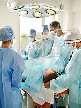 Woman on gurney in operating room.