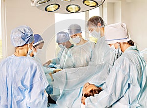 Woman on gurney in operating room.