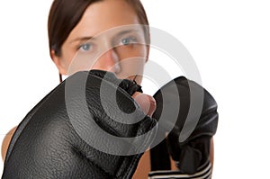 Woman in gym clothes, with boxing gloves, strength