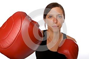 Woman in gym clothes, with boxing gloves, strength