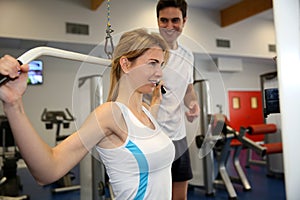 Woman in gym with coach